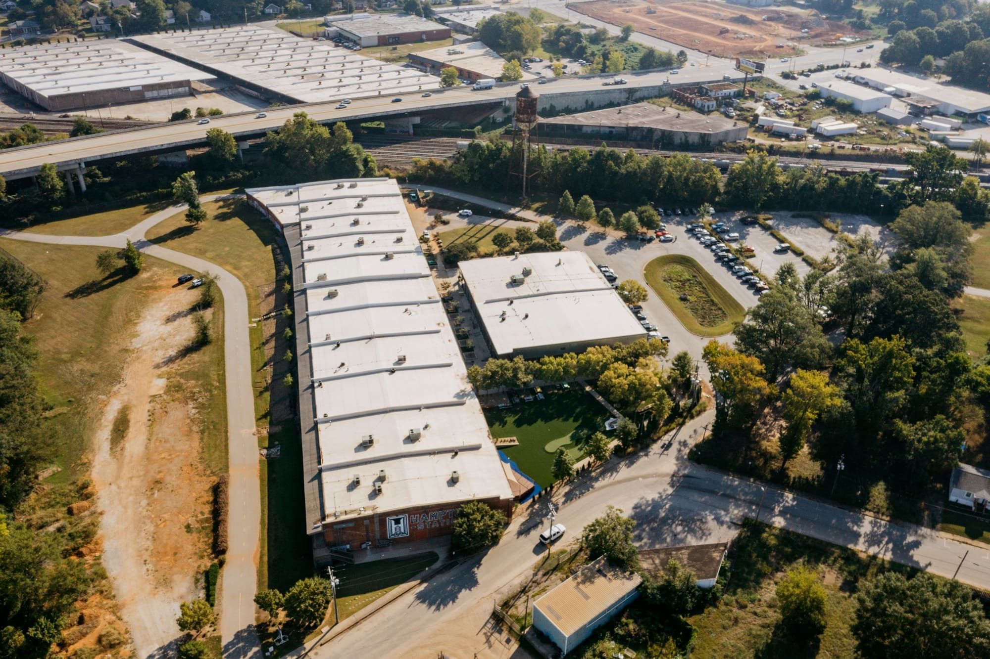Aerial view of long low-slope commercial buildings with light-colored roofs