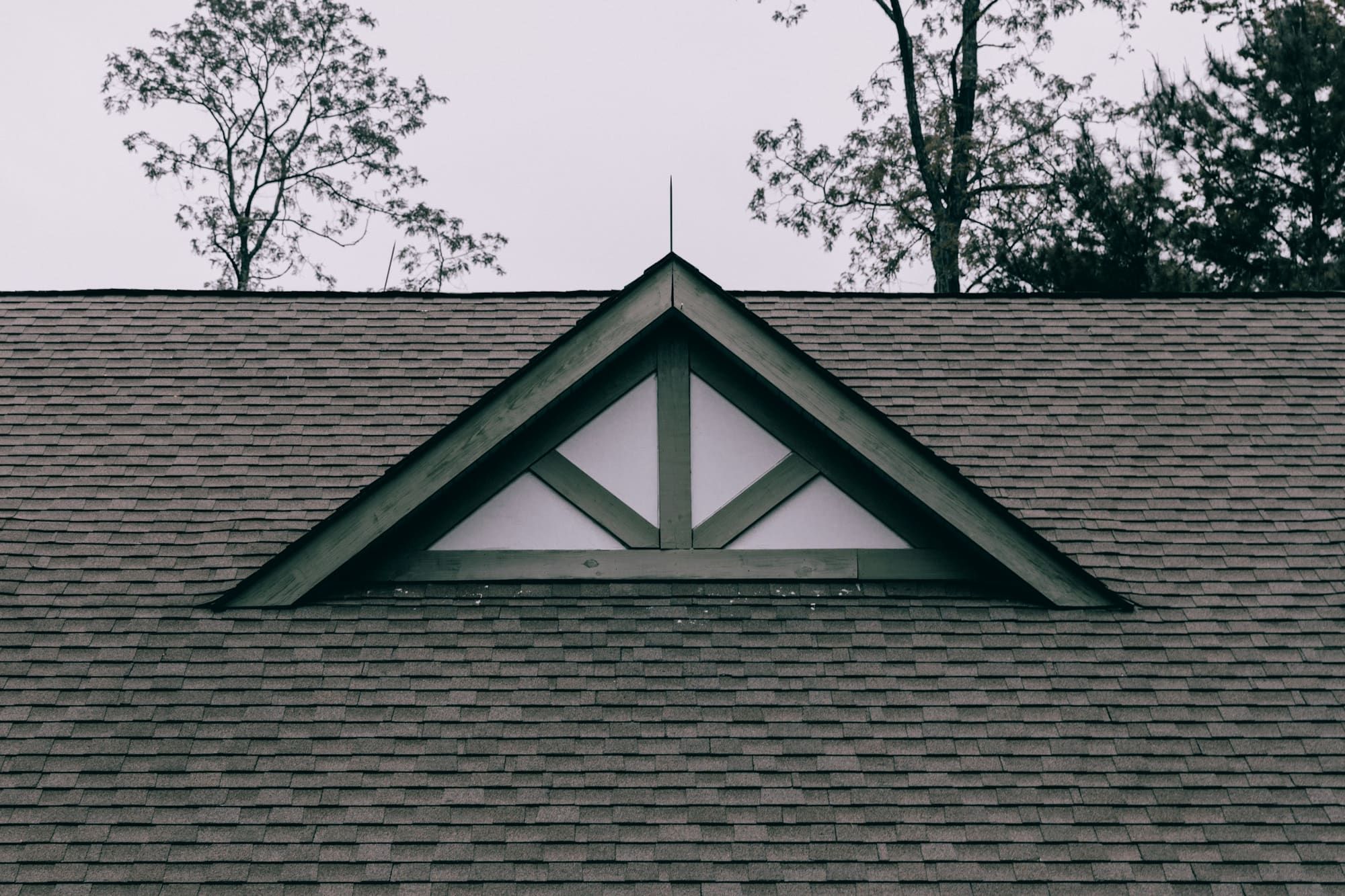 Gray architectural shingle roof with a decorative gable
