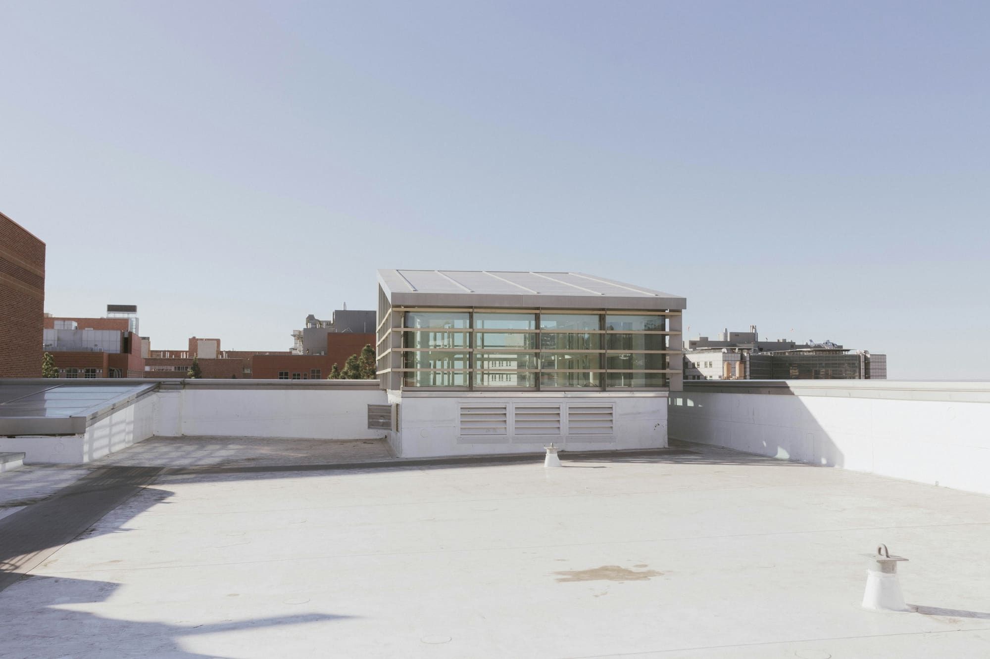 White single-ply membrane on a flat commercial roof with parapet walls